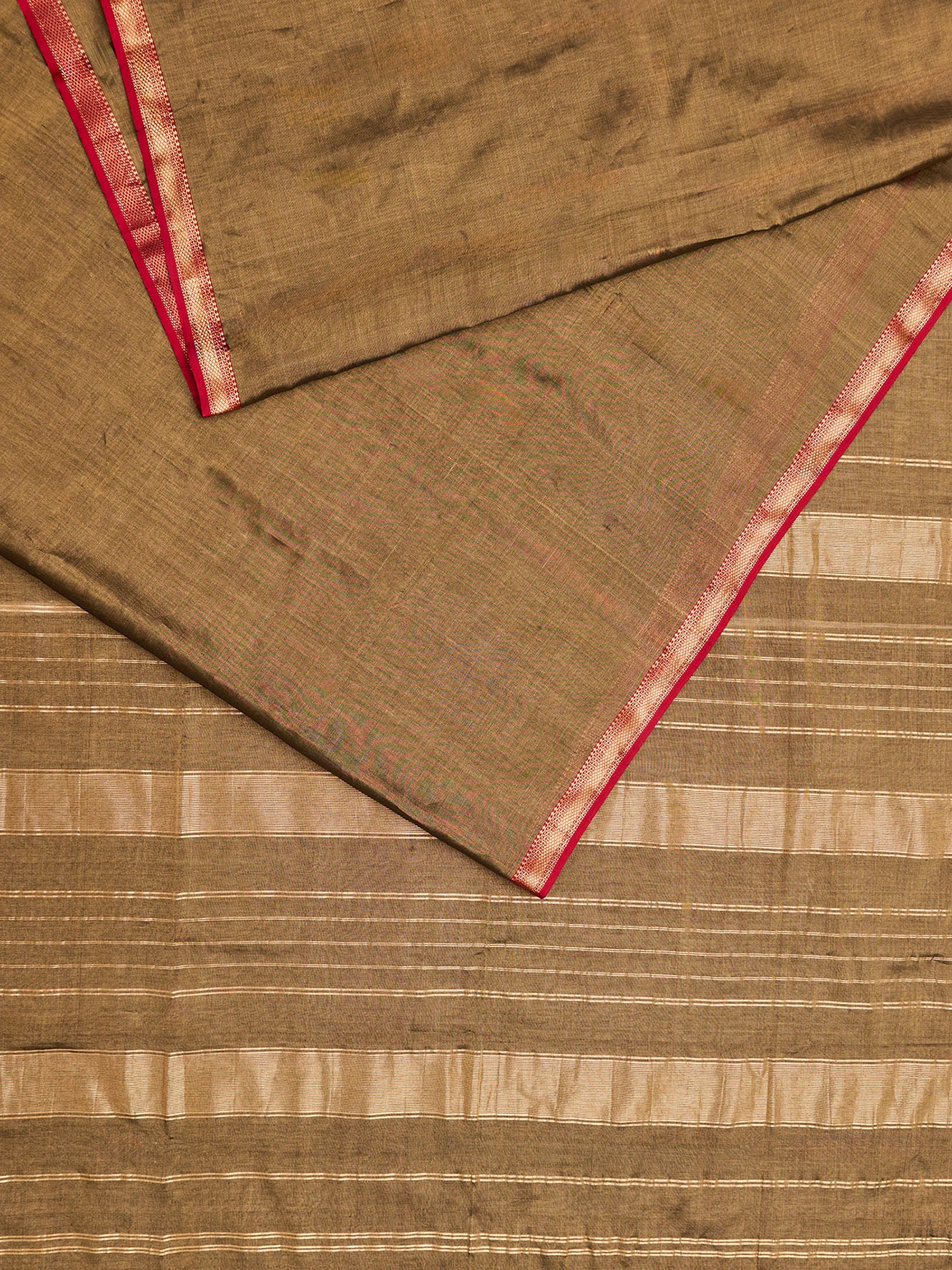 A maheshwari tissue saree in dual tone of black and gold displayed on a flat surface.