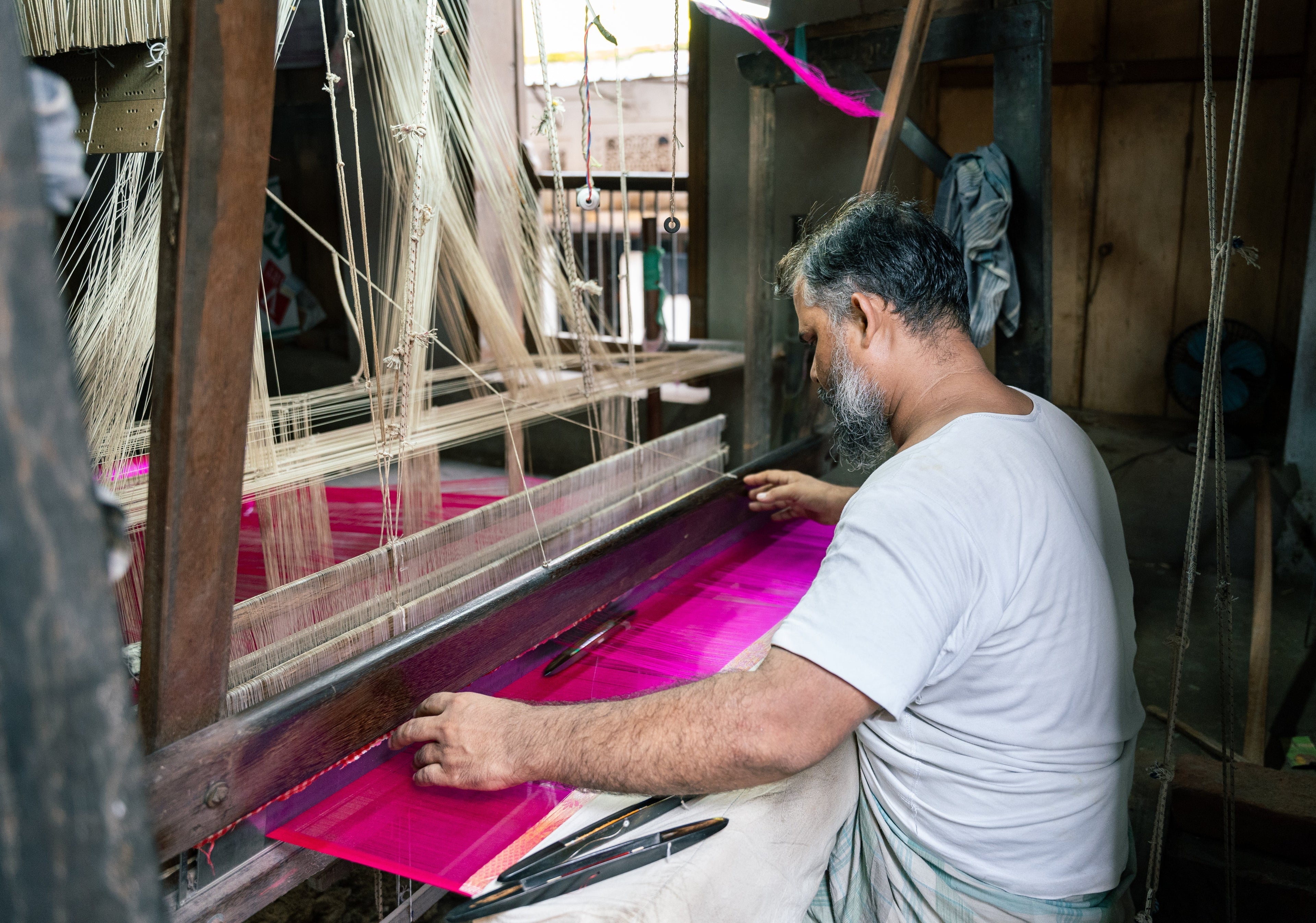 Artisan weaving a saree on a handloom