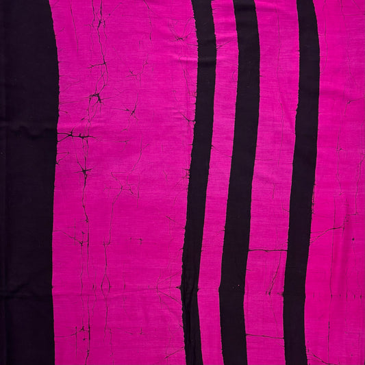 Black cotton saree with bright pink batik stripes on the body.