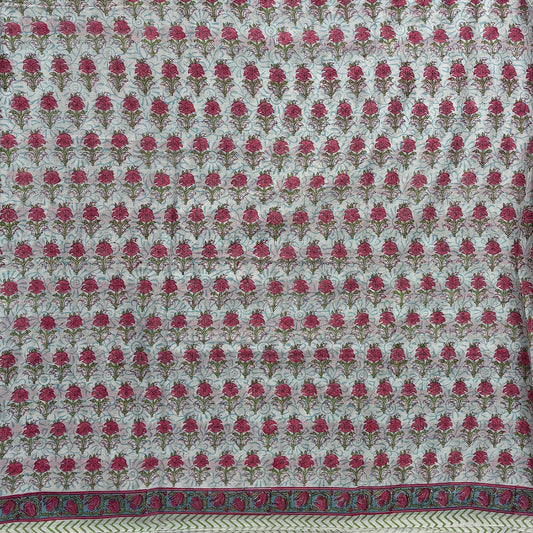Block printed saree with white base and pink flower booti all over.