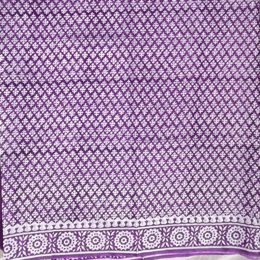 Close up of cotton handblock printed saree with white base and purple booti print.