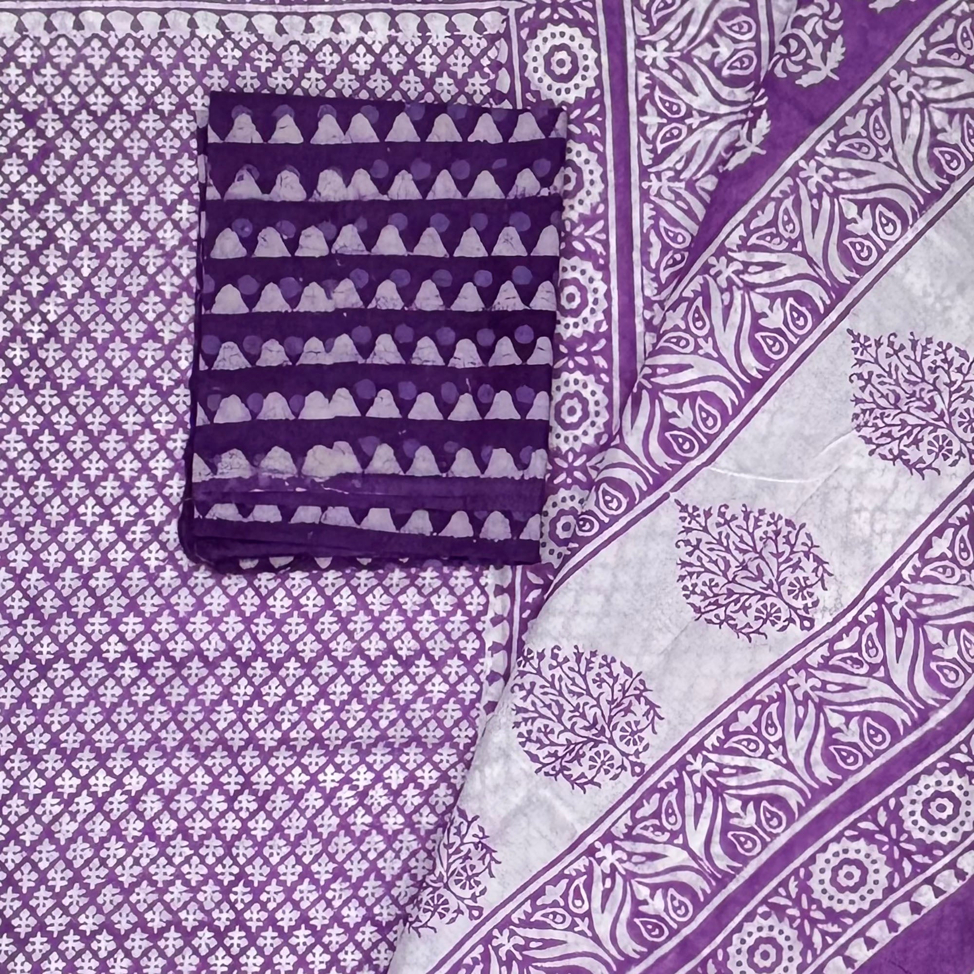 Close up of cotton handblock printed saree with white base and purple booti print with contrasting dark purple dabu print blouse.