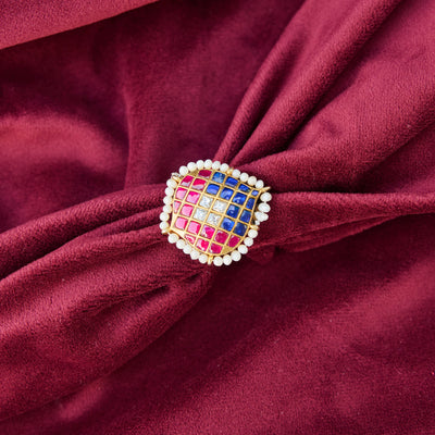 Gold plated silver ring in the shape of a spade rimmed with white pearls and topped with kundan in pink, blue and white stones.