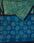 A green and blue combination tussar by modal saree in dabu handblock.
