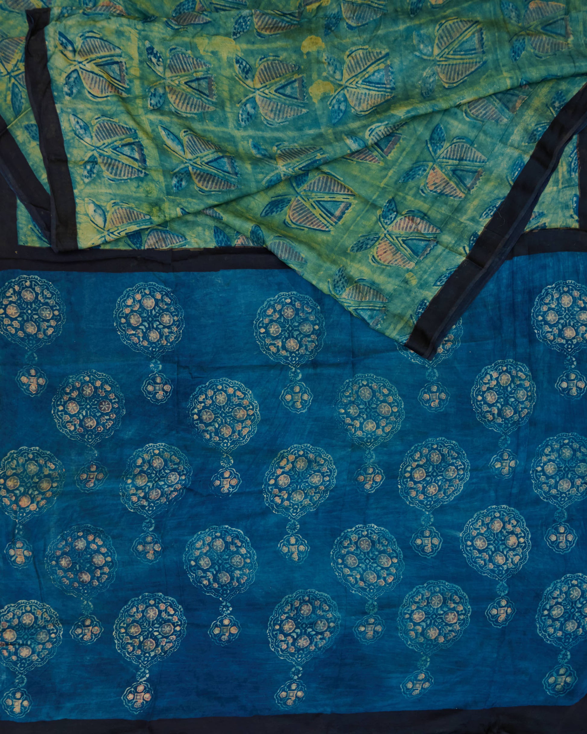 A green and blue combination tussar by modal saree in dabu handblock.