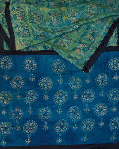 A green and blue combination tussar by modal saree in dabu handblock.