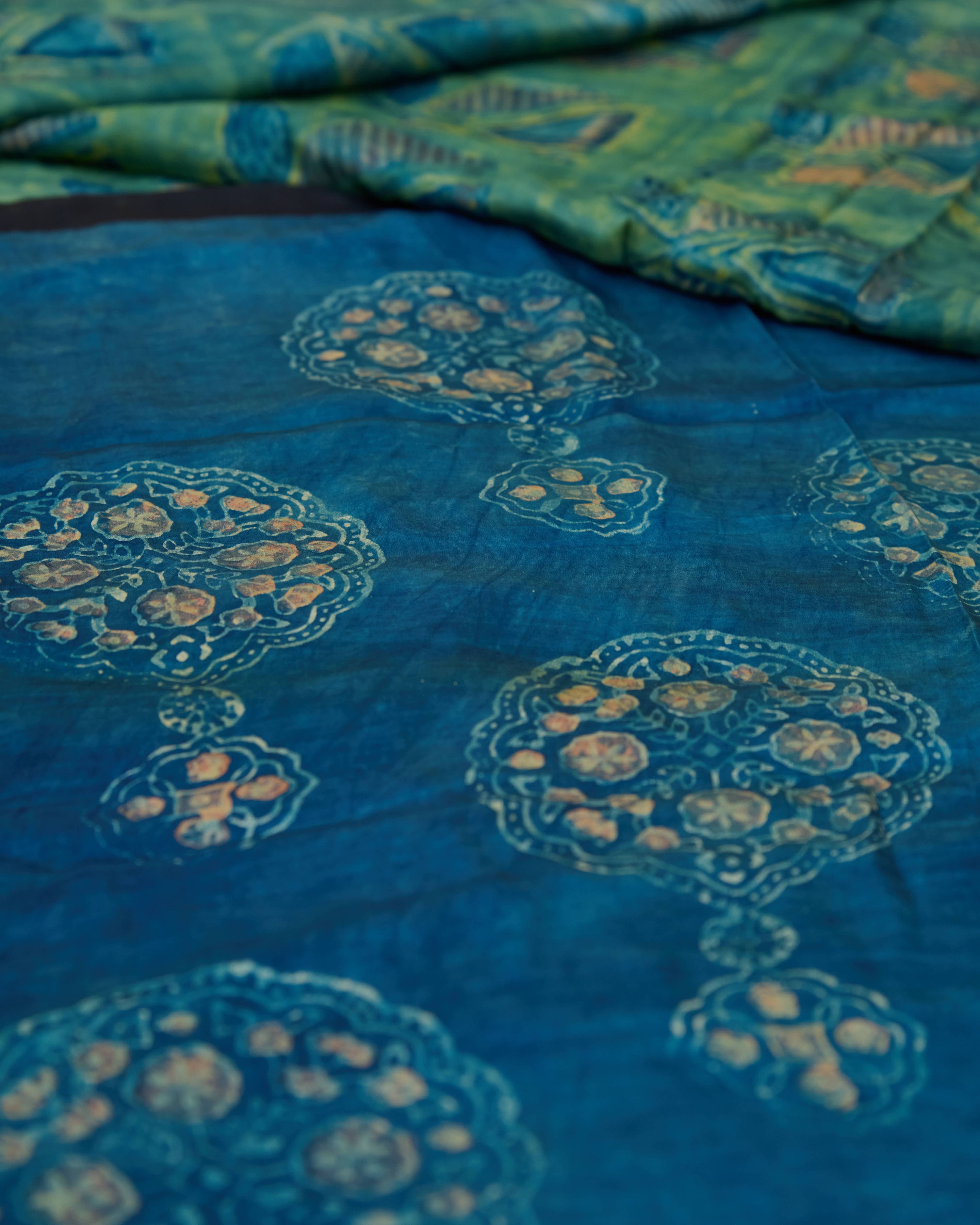 A green and blue combination tussar by modal saree in dabu handblock.