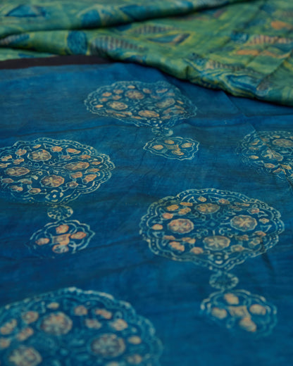 A green and blue combination tussar by modal saree in dabu handblock.