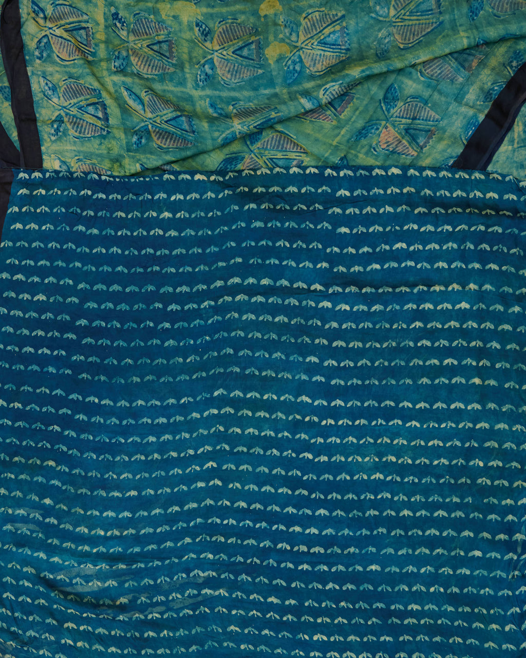 A green and blue combination tussar by modal saree in dabu handblock.