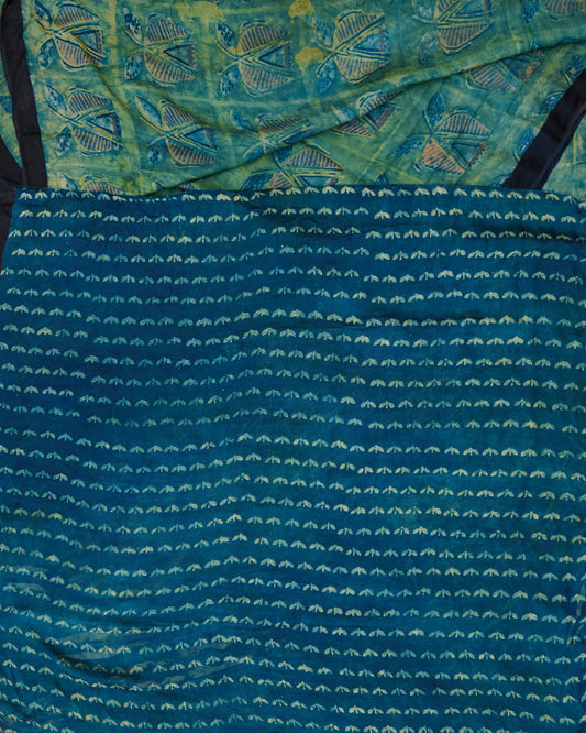 A green and blue combination tussar by modal saree in dabu handblock.