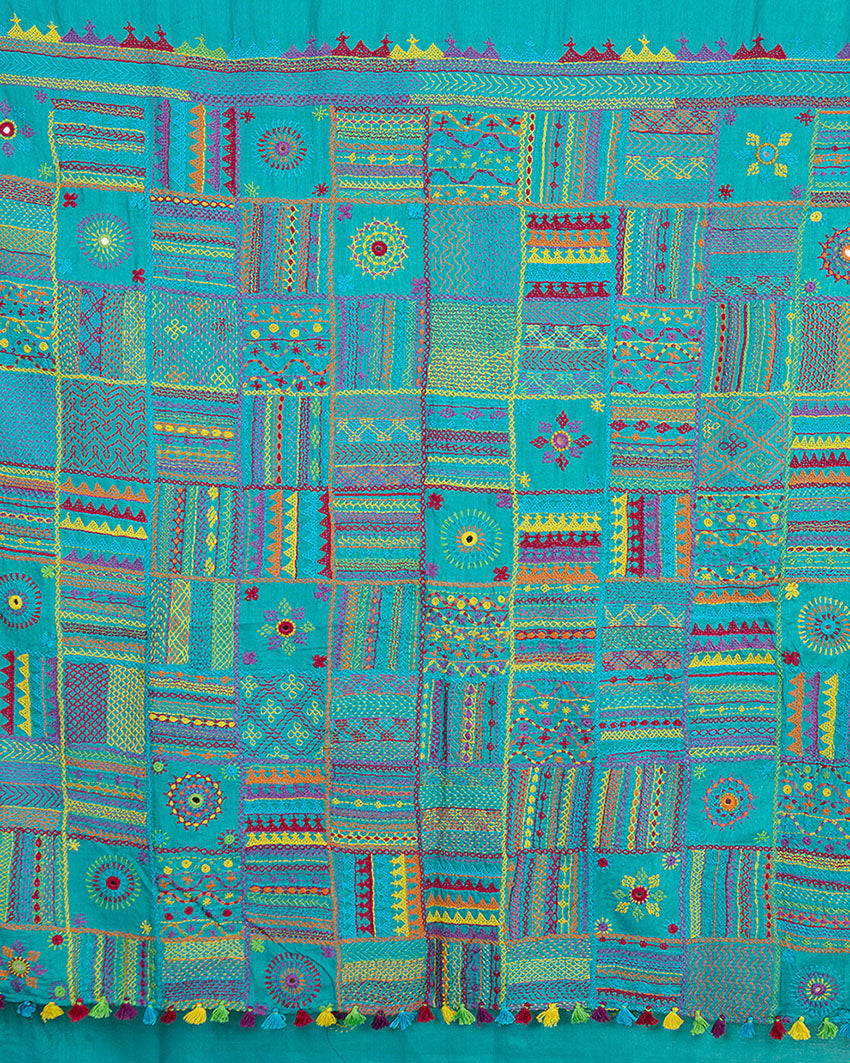 Close up of Lambani embroidery on the pallu of a Turquoise blue Kosa silk saree 