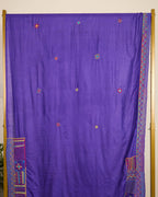 Purple Kosa silk saree with intricate Lambani embroidery booti on the body of the saree on display.