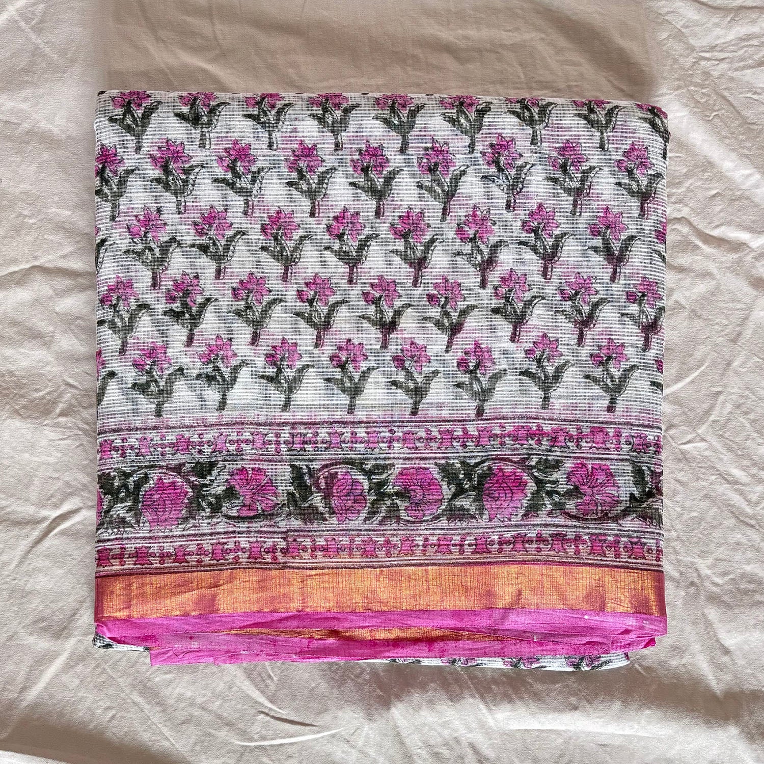 White kota cotton saree with Sanganeri floral booti blockprinted all over with a thin zari border.