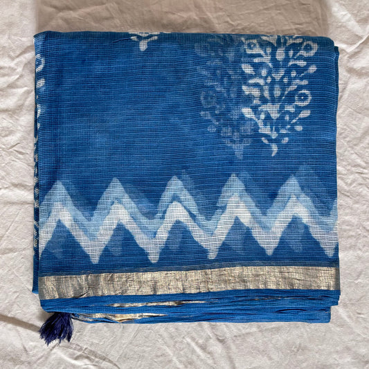 Indigo kota cotton saree with floral dabu booti in the body and zigzag pattern on the border with a thin zari border.