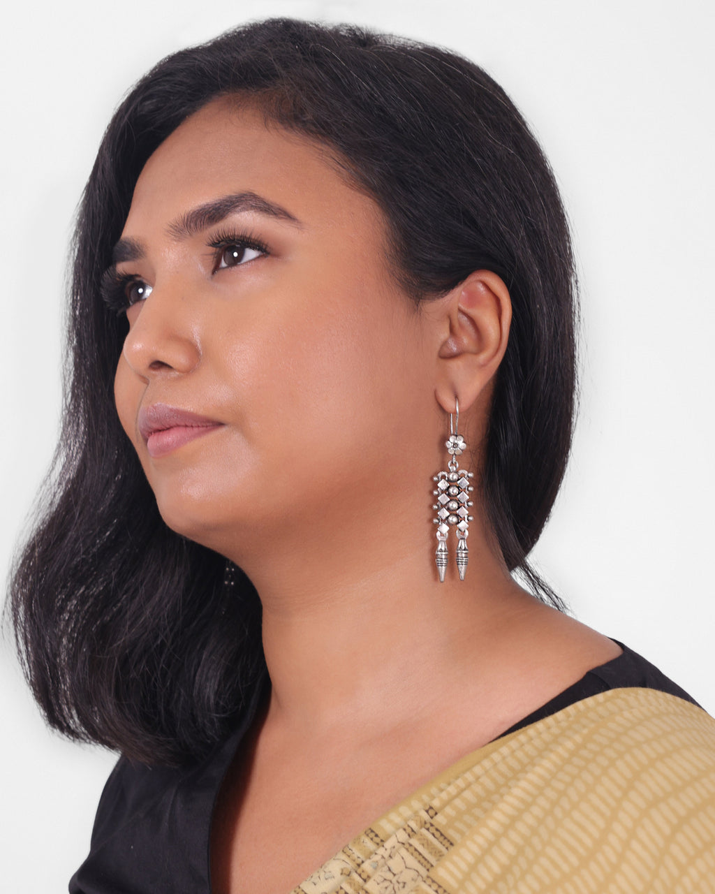 Model wearing a silver dangle earring