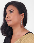 Model wearing a silver dangle earring