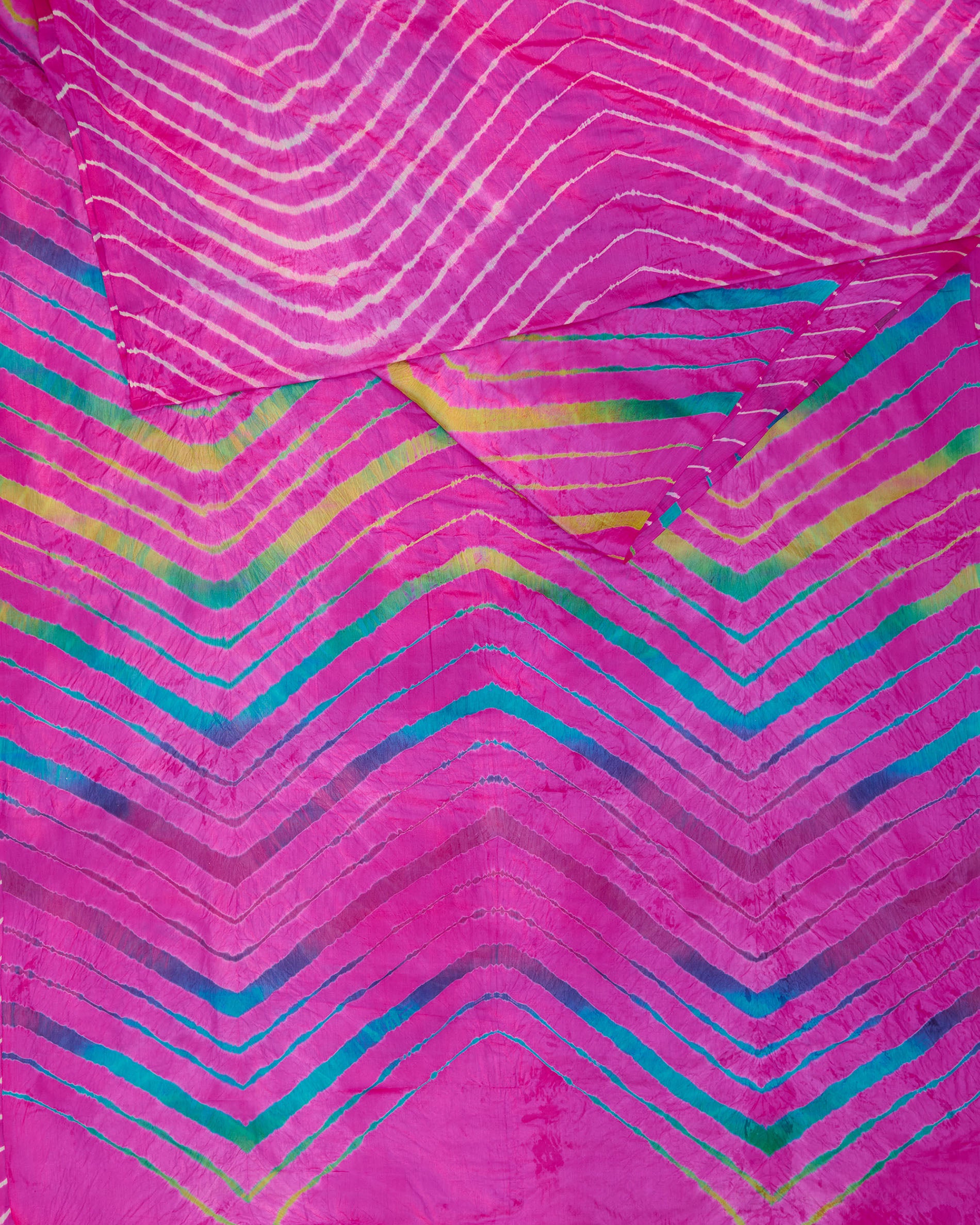 A pink toned leheriya saree with a multicolour leheriya tie-dye on pallu