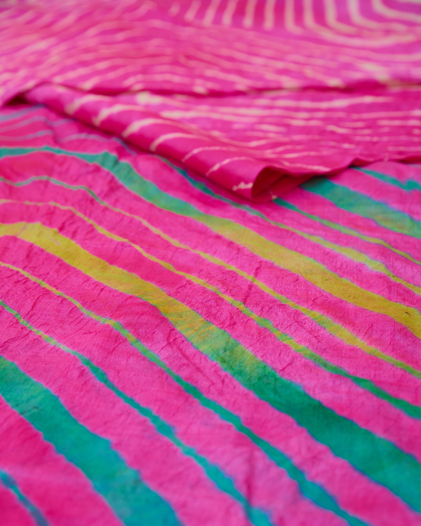 Close up of a pink toned multicolour leheriya saree
