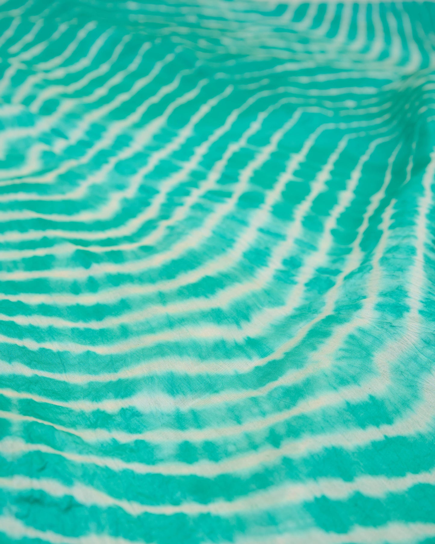 Close up of sea green leheriya saree