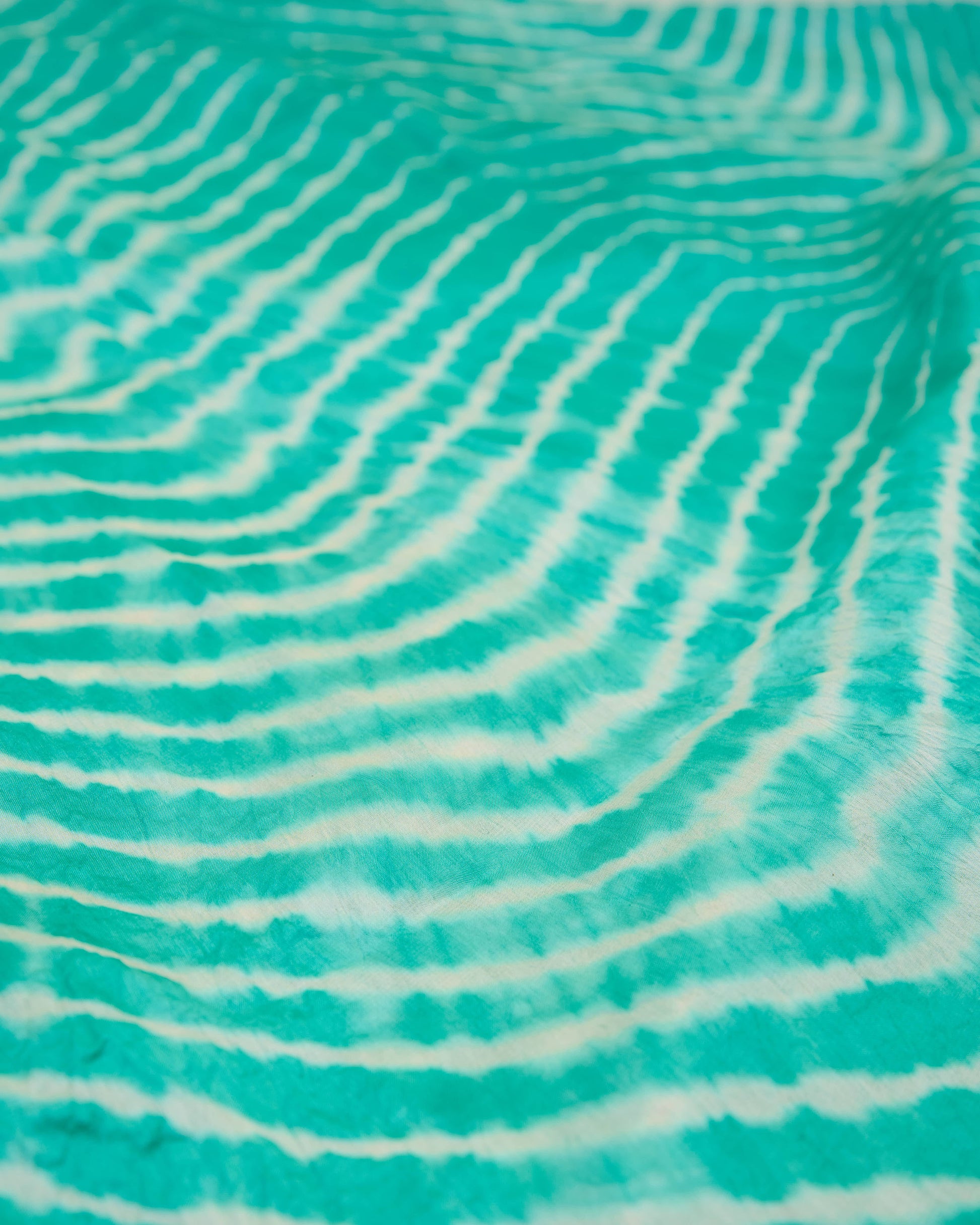 Close up of sea green leheriya saree