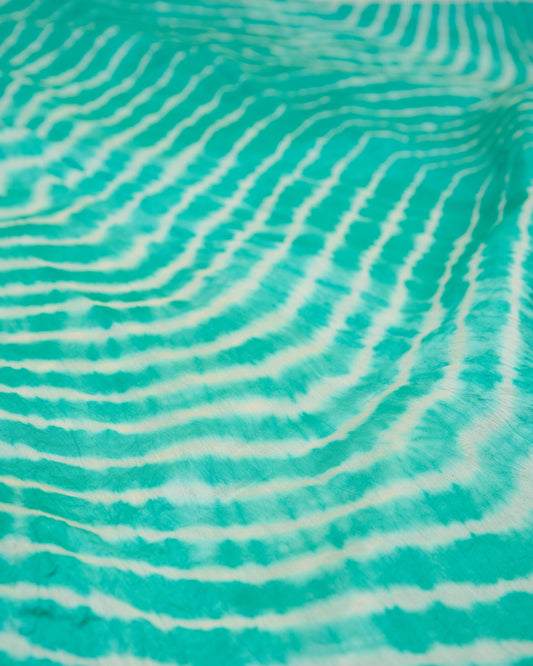 Close up of sea green leheriya saree