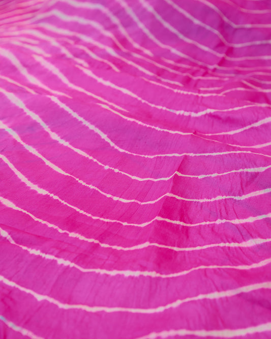 A pink toned leheriya close up of the saree