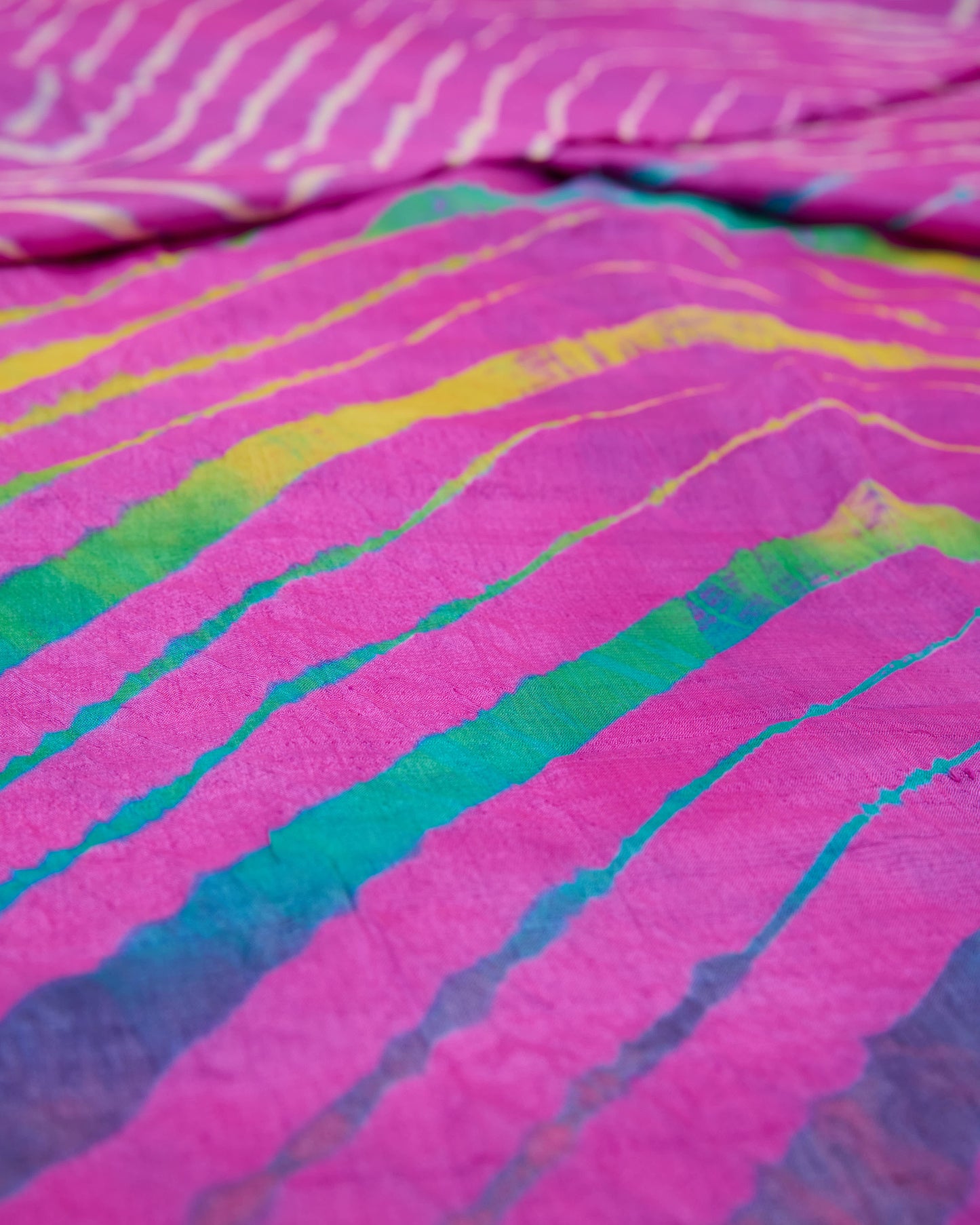 Close up of a pink toned multicolour leheriya saree