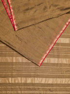 A maheshwari tissue saree in dual tone of black and gold displayed on a flat surface.