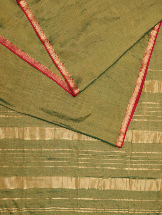 A maheshwari tissue saree in dual tone of dark green and gold on display on flat surface.