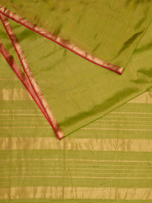 A maheshwari tissue saree in dual tone of light green and gold on display on a flat surface.