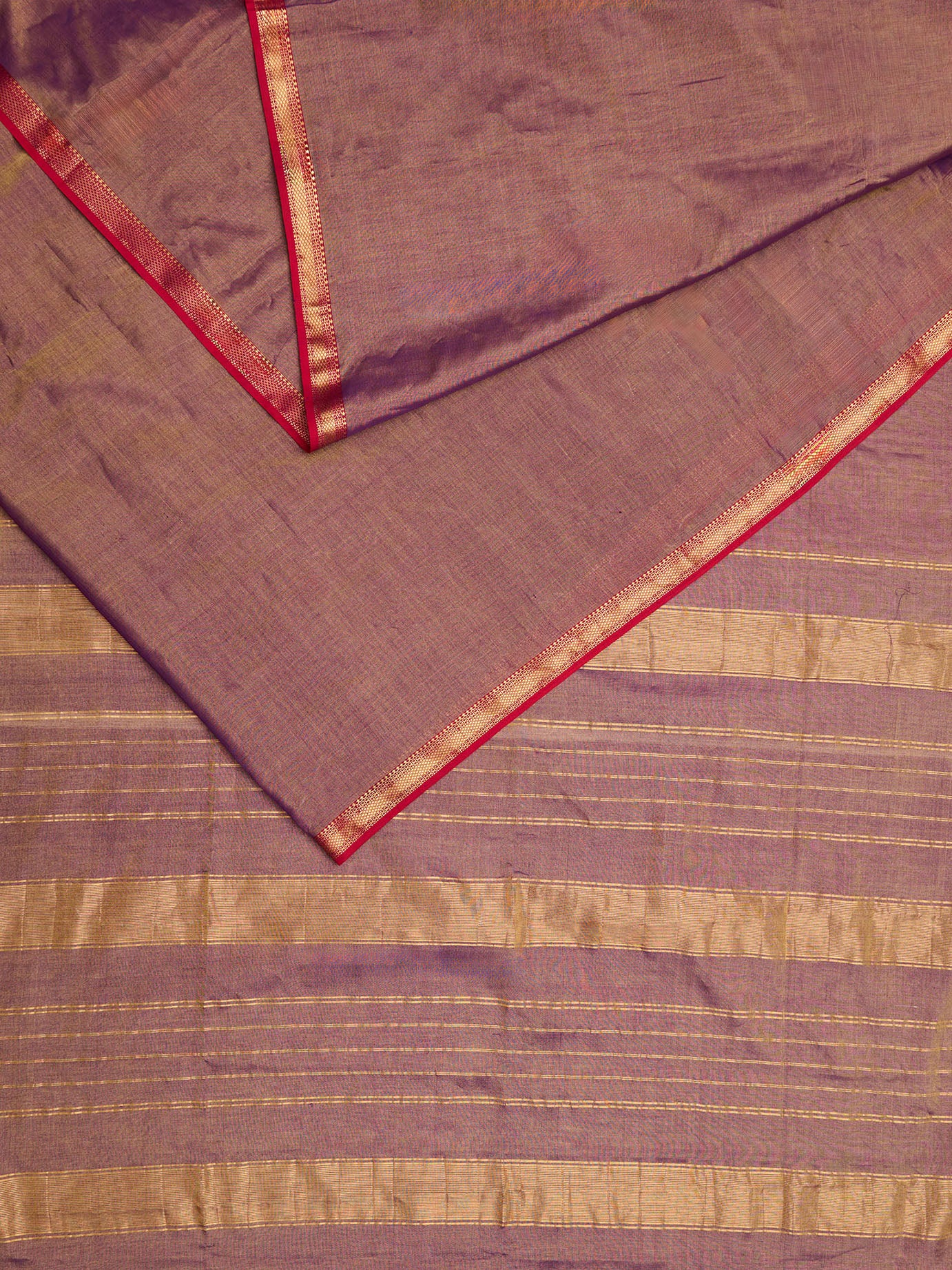 A dual tone Maheshwari Tissue saree in violet and gold displayed 