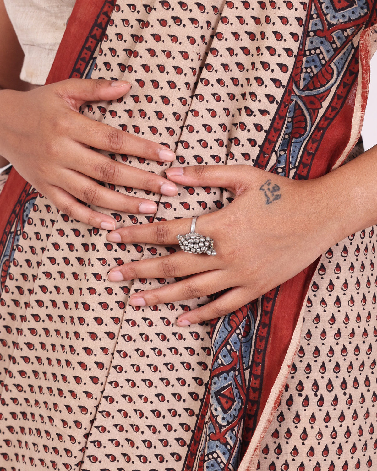 Model wearing a ghungroo ring shaped as a tortoise on her index finger. 