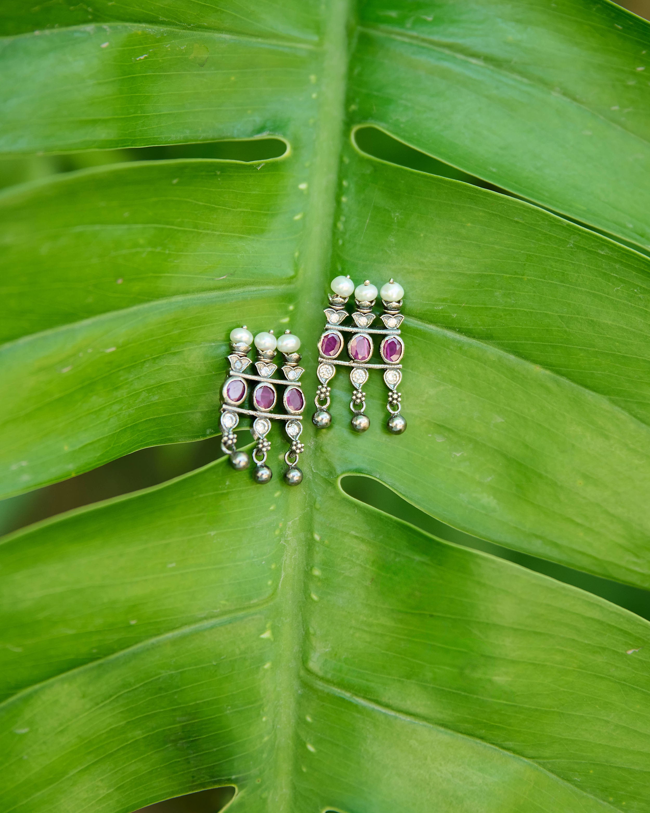 Kolhapuri saaj inspired earrings with red stones studded and pearls.