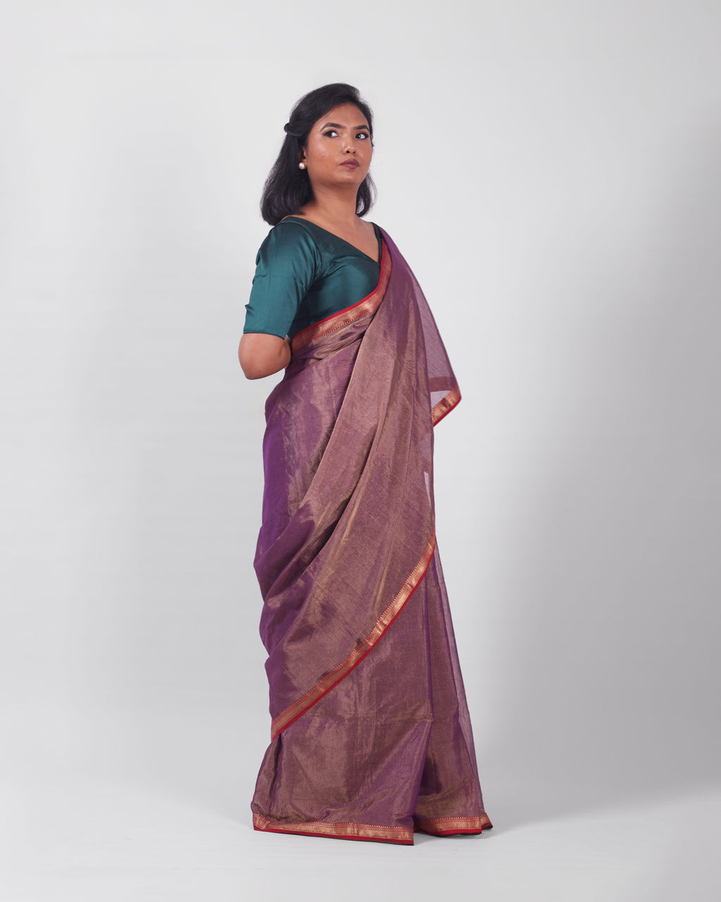 A model wearing our tissue silk maheshwari saree in the colour violet, with a traditional chasm-e-bulbul (diamond) border of maheshwari weaves. 