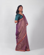 A model wearing our tissue silk maheshwari saree in the colour violet, with a traditional chasm-e-bulbul (diamond) border of maheshwari weaves. 