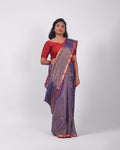 A model wearing our tissue silk maheshwari saree in the colour blue, with a traditional chasm-e-bulbul (diamond) border of maheshwari weaves. 