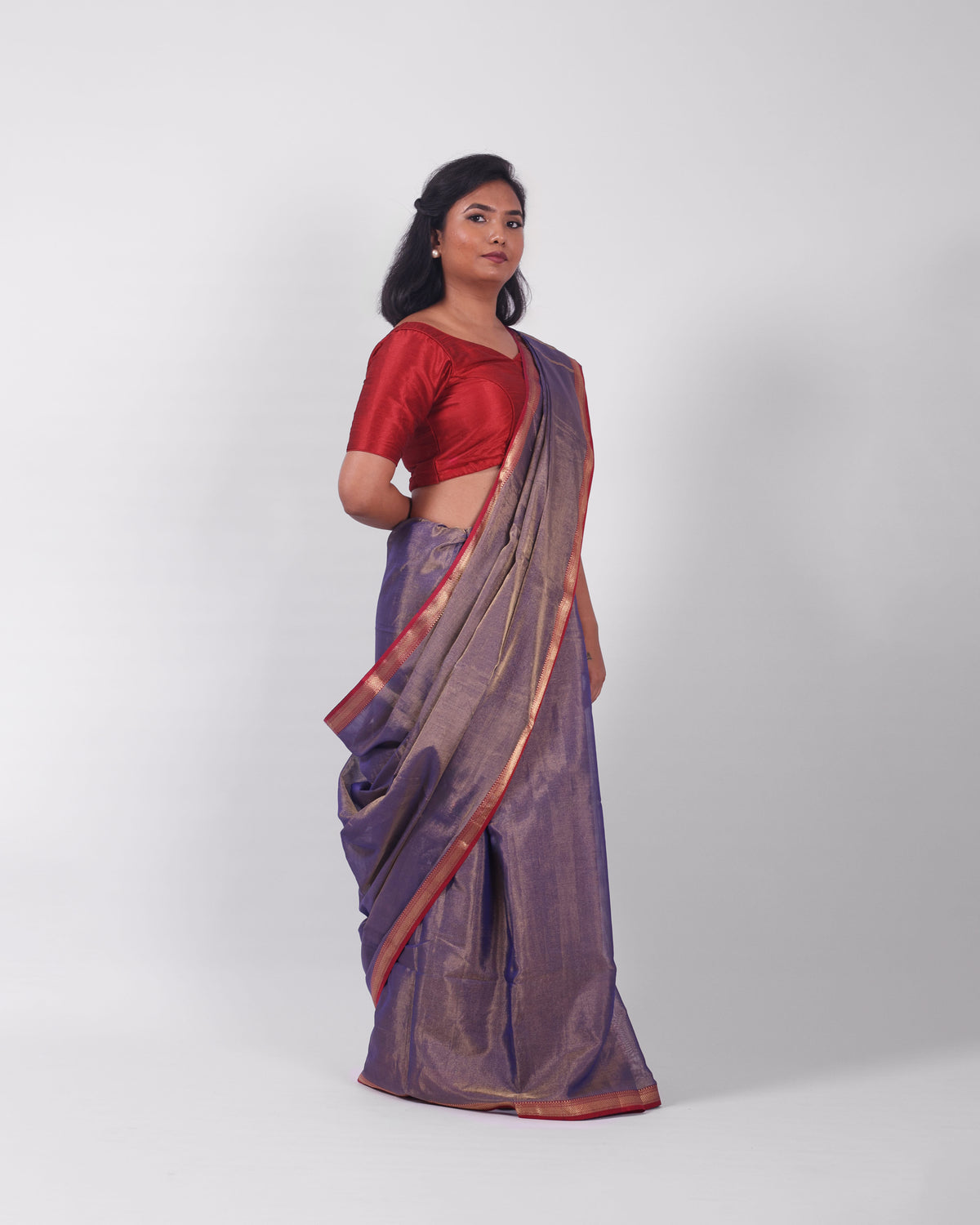 A model wearing our tissue silk maheshwari saree in the colour blue, with a traditional chasm-e-bulbul (diamond) border of maheshwari weaves. 