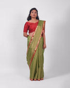 A model wearing our tissue silk maheshwari saree in the colour light green, with a traditional chasm-e-bulbul (diamond) border of maheshwari weaves. 