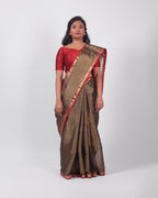A model wearing our tissue silk maheshwari saree in the colour black, with a traditional chasm-e-bulbul (diamond) border of maheshwari weaves. 