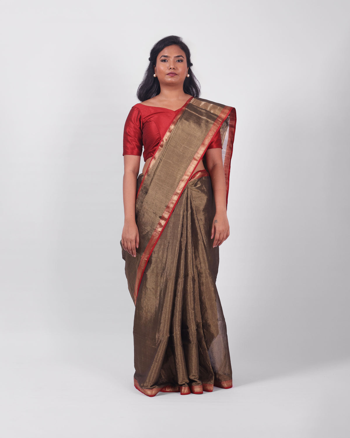 A model wearing our tissue silk maheshwari saree in the colour black, with a traditional chasm-e-bulbul (diamond) border of maheshwari weaves. 
