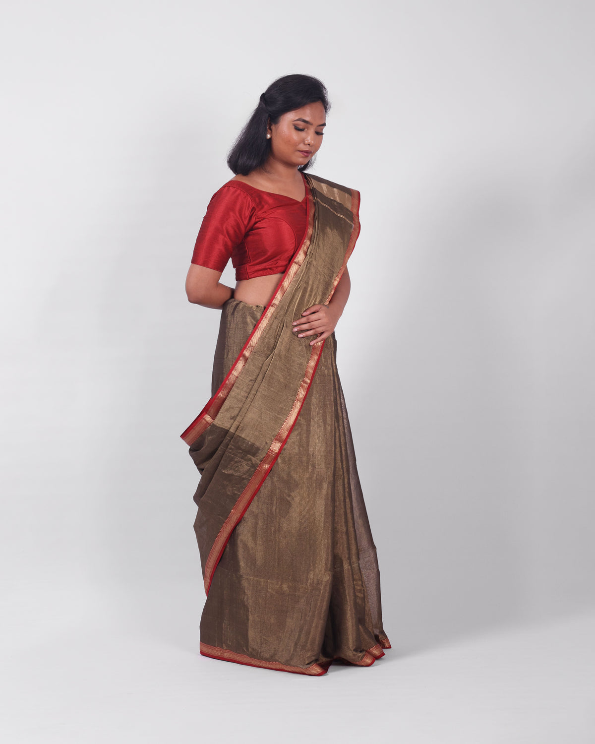 A model wearing our tissue silk maheshwari saree in the colour black, with a traditional chasm-e-bulbul (diamond) border of maheshwari weaves. 