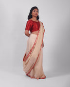 A model wearing our tissue silk maheshwari saree in the colour off white, with a traditional chasm-e-bulbul (diamond) border of maheshwari weaves. 