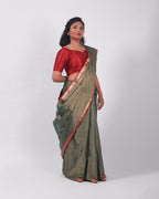 A model wearing our tissue silk maheshwari saree in the colour dark green, with a traditional chasm-e-bulbul (diamond) border of maheshwari weaves. 