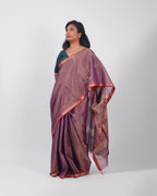 A model wearing our tissue silk maheshwari saree in the colour violet, with a traditional chasm-e-bulbul (diamond) border of maheshwari weaves. 