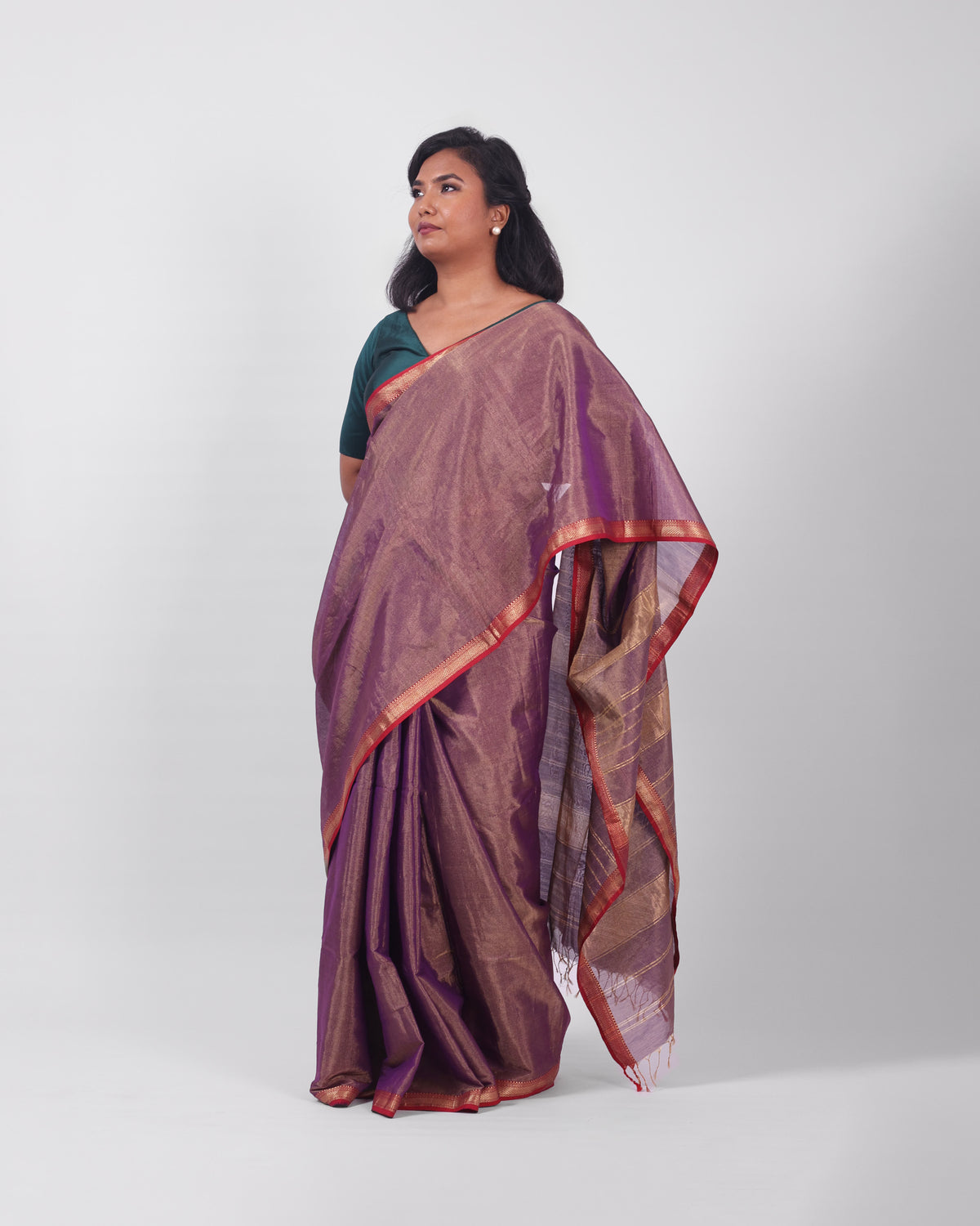 A model wearing our tissue silk maheshwari saree in the colour violet, with a traditional chasm-e-bulbul (diamond) border of maheshwari weaves. 