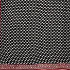 Black base colour cotton block printed saree with small beige paisley booti all over and red border.
