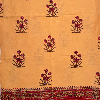 Fawn colour cotton saree with Mughal floral block print all over and a red border.