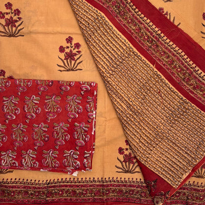 Fawn colour cotton saree with Mughal floral block print all over, with contrasting red blockprinted blouse material and pallu on display.