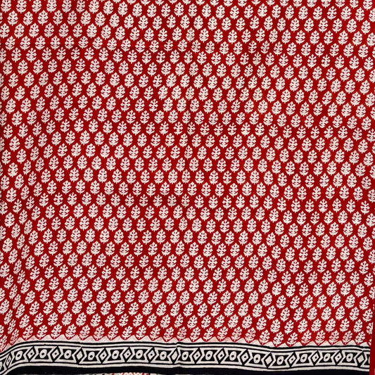 Red base colour cotton block printed saree with all over floral beige booti and black border.
