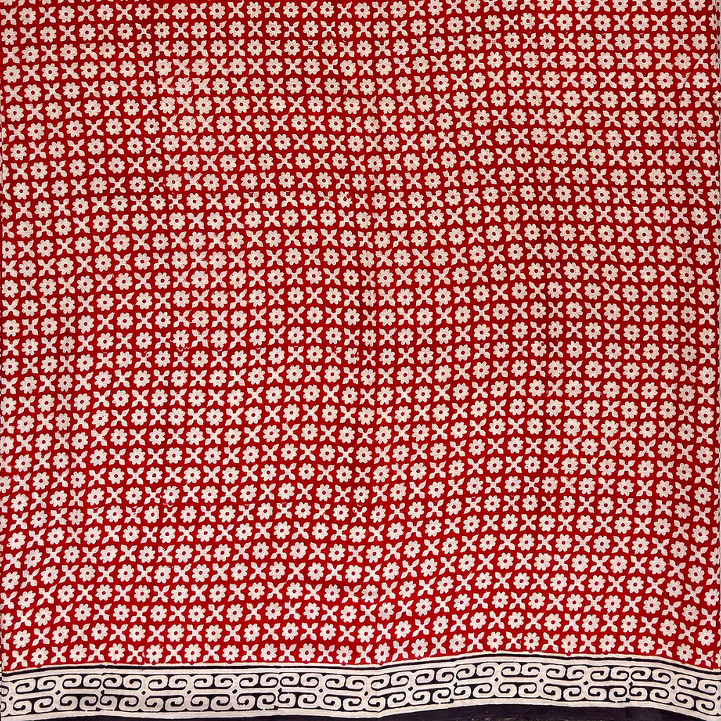 Red base colour cotton block printed saree with small beige flower booti print all over and a black border.